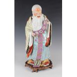 A Chinese famille rose porcelain figure of Shoulao, 20th century, modelled standing wearing a