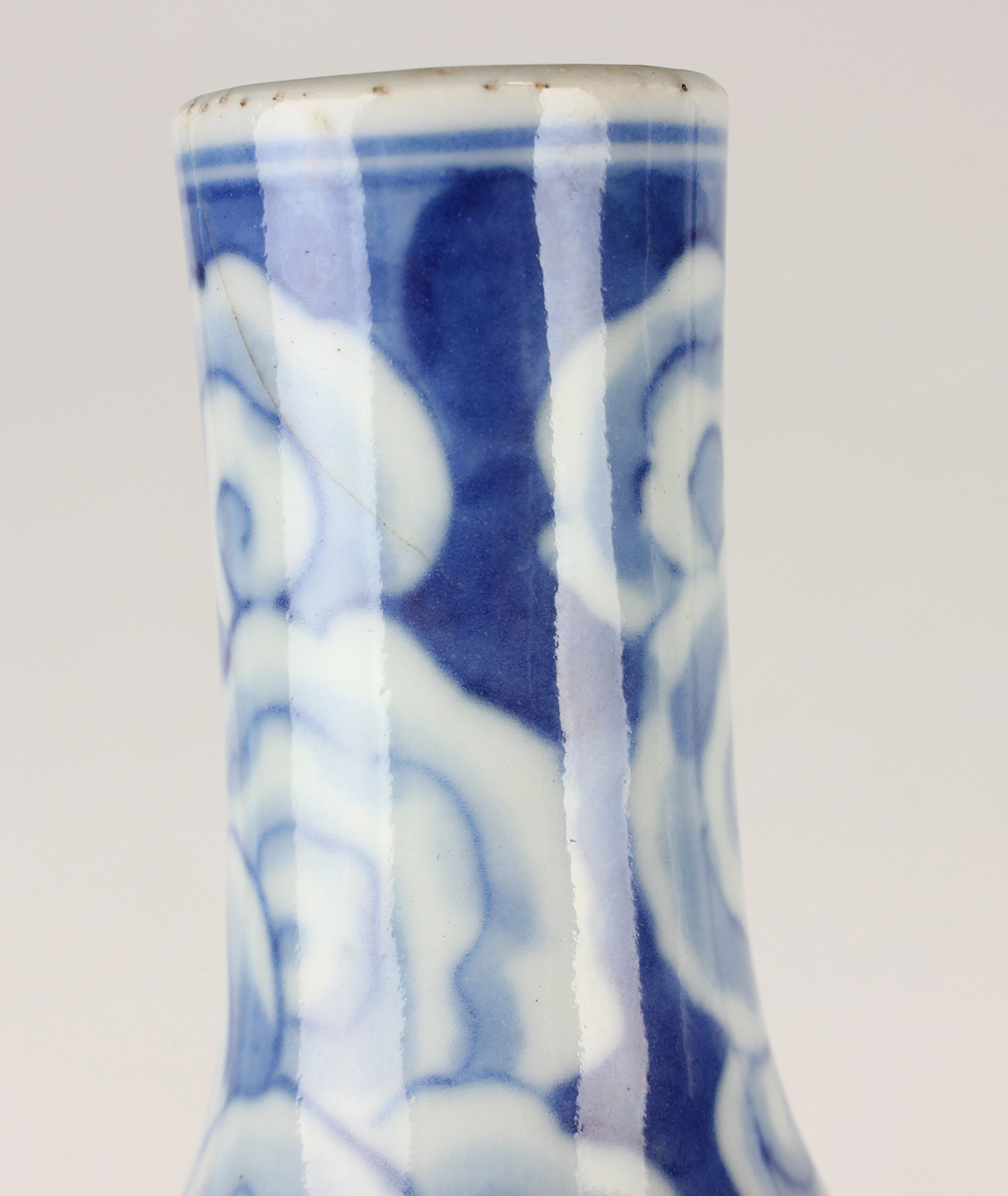 A Chinese blue and white porcelain bottle vase, Qing dynasty, painted with a dragon emerging through - Image 9 of 16