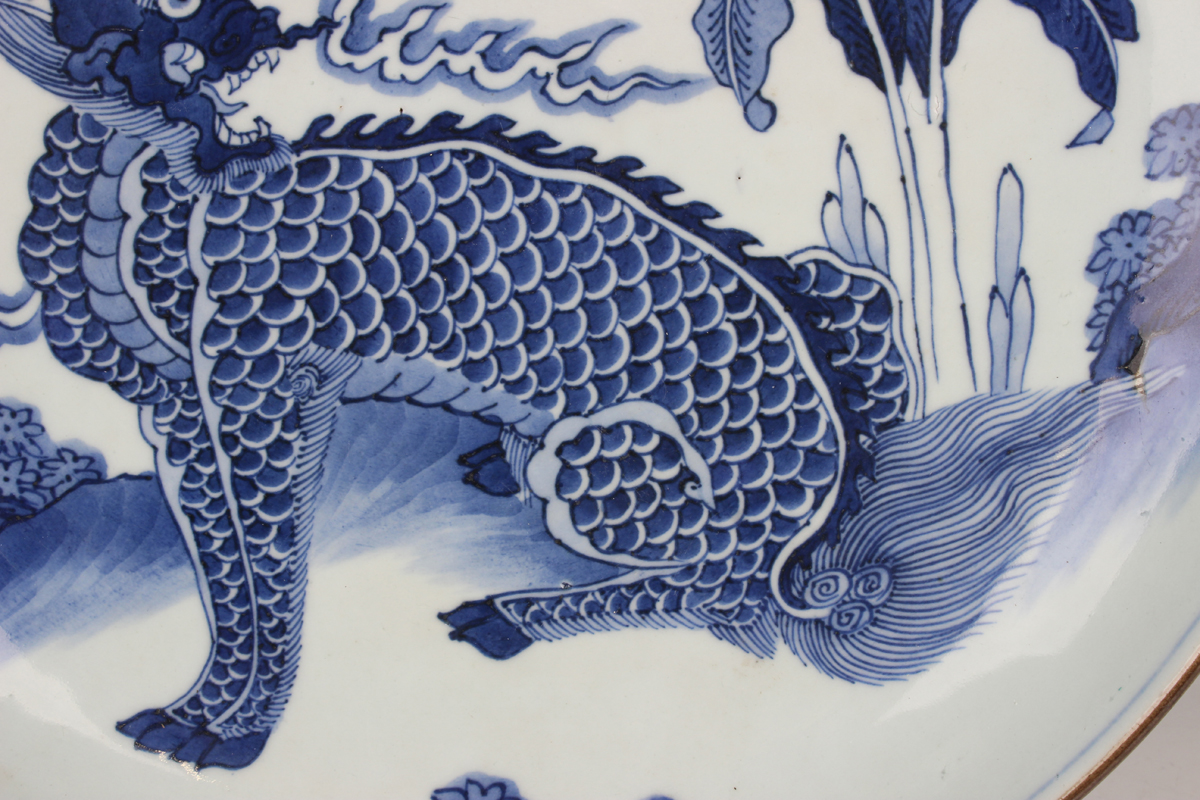 A Chinese blue and white porcelain circular dish, late Qing dynasty, painted with a seated kylin, - Image 6 of 7