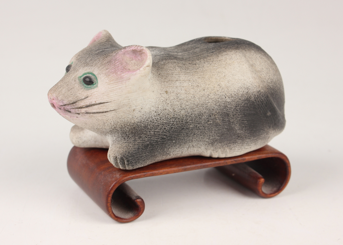 A Chinese pottery water dropper, late Qing dynasty, modelled as a recumbent mouse with painted