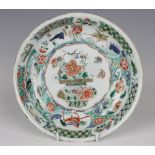 A Chinese famille verte export porcelain saucer dish, Kangxi period, the centre painted with a