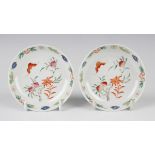 A pair of Chinese famille rose porcelain saucer dishes, 20th century, each painted with a bat and