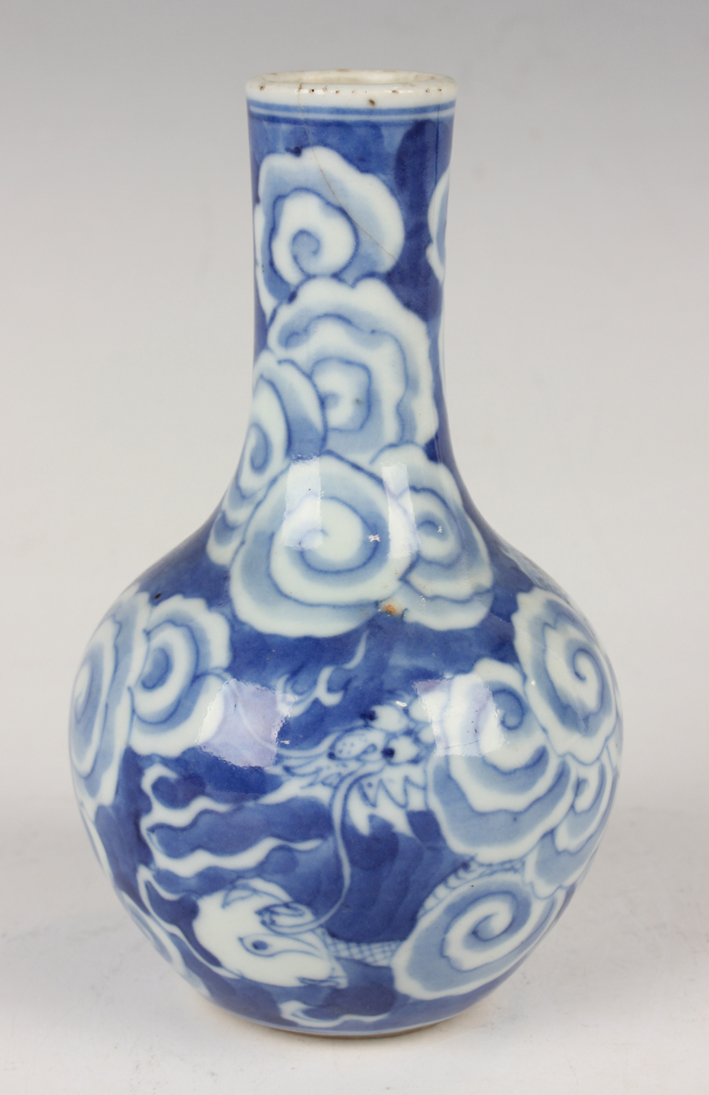 A Chinese blue and white porcelain bottle vase, Qing dynasty, painted with a dragon emerging through - Image 16 of 16