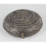 A South-east Asian white metal and parcel gilt circular box and cover, probably Tibetan or Chinese