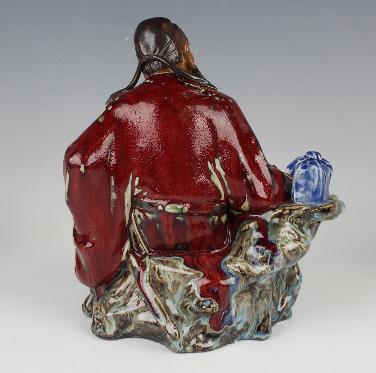 A Chinese Shiwan pottery sang-de-boeuf glazed figure of Guan Yu, modelled in a seated pose, - Image 19 of 22