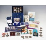 A collection of various coins, numismatic folders, coin envelopes and magnifiers, including a