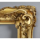 A 19th century carved, pierced and gilt wood frame of wide section, with foliate strapwork and