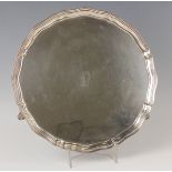 An Edward VIII silver circular salver, initial engraved within a raised piecrust rim, on scroll