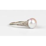 An 18ct gold, palladium, cultured pearl and diamond ring, mounted with the single cultured pearl