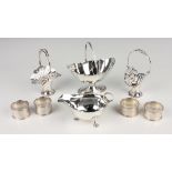 A pair of George V silver swing handled posy baskets, each pierced and cast with scrolls, Chester