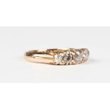 A gold and diamond five stone ring, early 20th century, claw set with a row of cushion cut