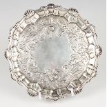 A George III silver circular card salver, the centre engraved with flowers and scrolling leaves