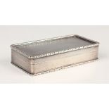 An Elizabeth II silver rectangular snuff box with engine turned decoration within raised cast flower
