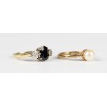 A gold ring, claw set with an oval cut sapphire between two circular cut diamonds, partial marks,