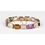 A gold and varicoloured gemstone bracelet, circa 1940, claw set with various rectangular cut