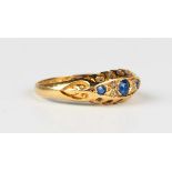 An 18ct gold, sapphire and diamond ring, mounted with three sapphires and two pairs of diamonds,