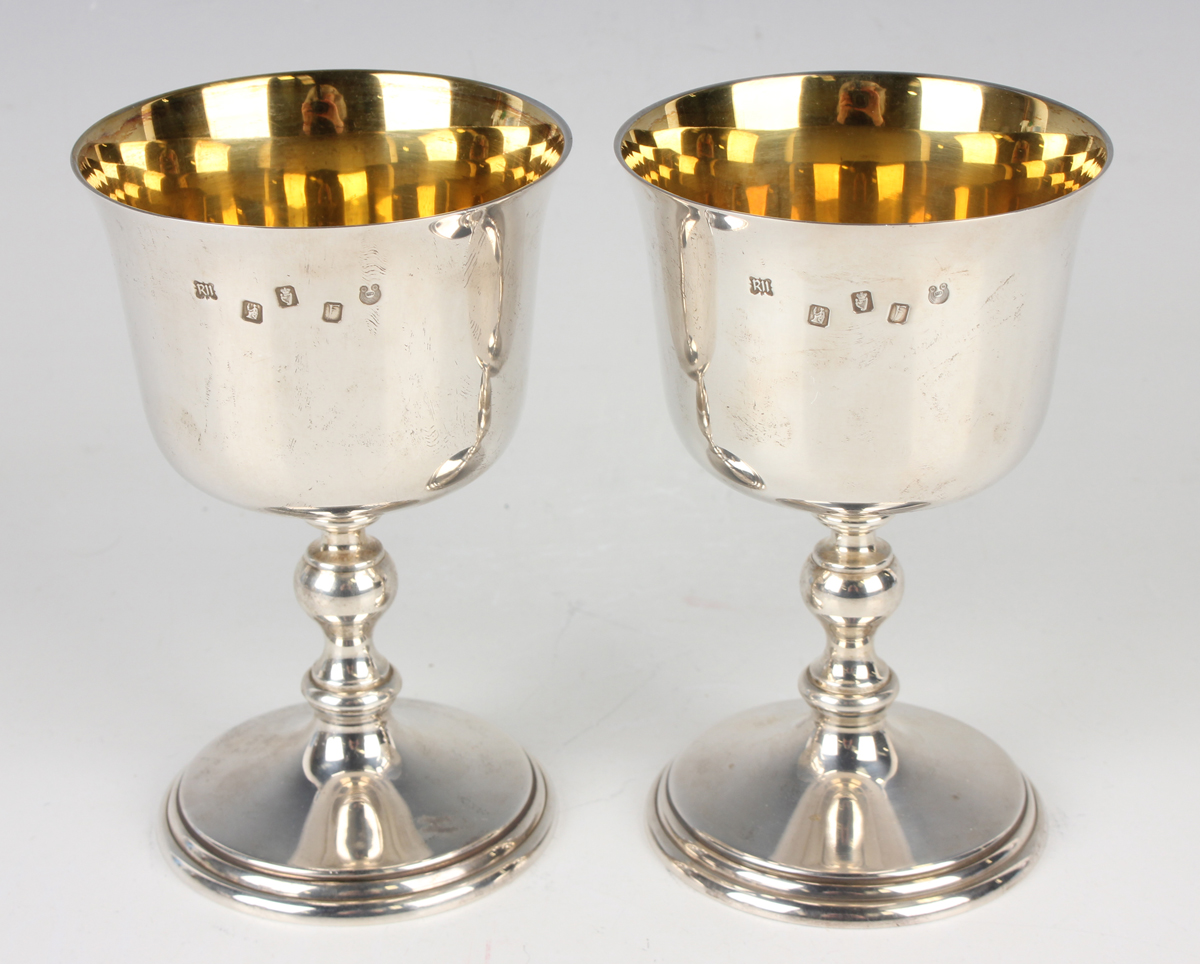 A pair of Elizabeth II Irish silver goblets, each slightly flared bowl with gilt interior, on a