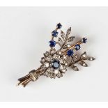 A gold backed and silver set, sapphire and diamond brooch, circa 1900, designed as a floral and
