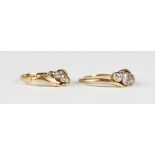 A gold and diamond three stone ring, collet set with cushion cut diamonds in a twistover design,