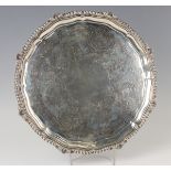 A late Victorian silver circular salver, the centre engraved with scallop shells and flower