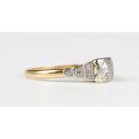 A gold and diamond ring, mounted with the principal circular cut diamond in a square shaped