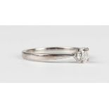 An 18ct white gold ring, claw set with a circular cut diamond, weight 2.4g, diamond weight approx