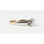 A gold and diamond single stone ring, claw set with a cushion cut diamond, detailed '18ct', weight