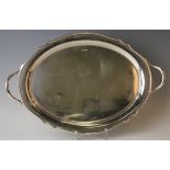 A George V silver oval tea tray with shaped rim flanked by a pair of handles, Sheffield 1931 by