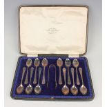 A set of twelve George V silver teaspoons and pair of matching sugar tongs, Sheffield 1920 and