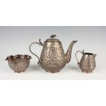 A 19th century Indian silver three-piece tea set, comprising teapot, milk jug and sugar bowl, each