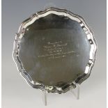 An Elizabeth II silver circular salver, the centre inscription engraved within a raised piecrust