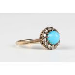 A gold, turquoise and diamond cluster ring, claw set with the cabochon turquoise within a surround