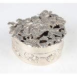 An Edwardian silver hemispherical shaped potpourri box with cast and pierced floral and butterfly