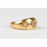 An Edwardian 18ct gold and diamond three stone ring, star gypsy set with cushion cut diamonds,