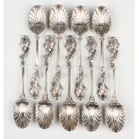 A set of nine George II silver teaspoons, each with a scallop bowl and rococo scroll terminal,