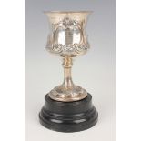 A Victorian silver goblet, the waisted circular body chased with a scroll cartouche, later