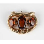 A Victorian gold and citrine three stone brooch, collet set with a row of three oval cut citrines