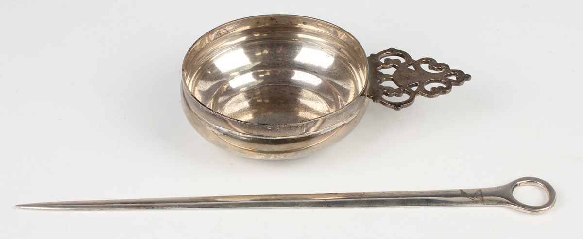 A George V silver circular bowl, the tab handle with pierced decoration, London 1934 by Jones & Son,