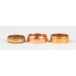 A 9ct gold wedding ring, Birmingham 1914, ring size approx Q, and two 9ct gold decorated wedding