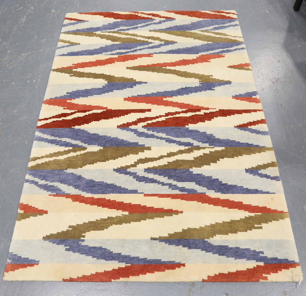 A contemporary design rug, modern, the ivory field with geometric polychrome bands, 180cm x 125cm.