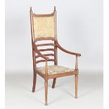 An Edwardian Arts and Crafts mahogany framed ladder back elbow chair by Hampton & Sons of Pall Mall,