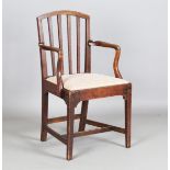 A George III provincial oak framed comb back elbow chair with a drop-in seat, height 98cm, width