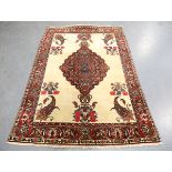 A Bakhtiari rug, North-west Persia, mid-20th century, the ivory field with a shaped medallion,