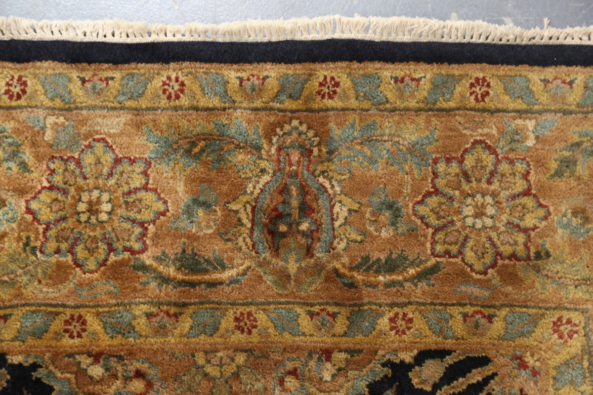 An Indian carpet, late 20th century, the charcoal field with overall palmettes, flowerheads and - Image 4 of 6