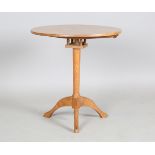 A mid-20th century Arts and Crafts Cotswold School oak tip-top circular wine table, the tripod
