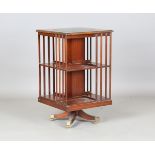 A late 20th century Bevan Funnell Reprodux mahogany revolving bookcase with a green leather inset