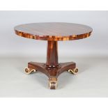 A Regency rosewood circular tip-top breakfast table, raised on a triform base with gilded scroll