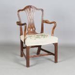 A George III Chippendale period mahogany pierced splat back elbow chair with shaped armrests and