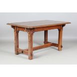 A late Victorian Gothic Revival oak refectory table, the rectangular top with a carved edge,