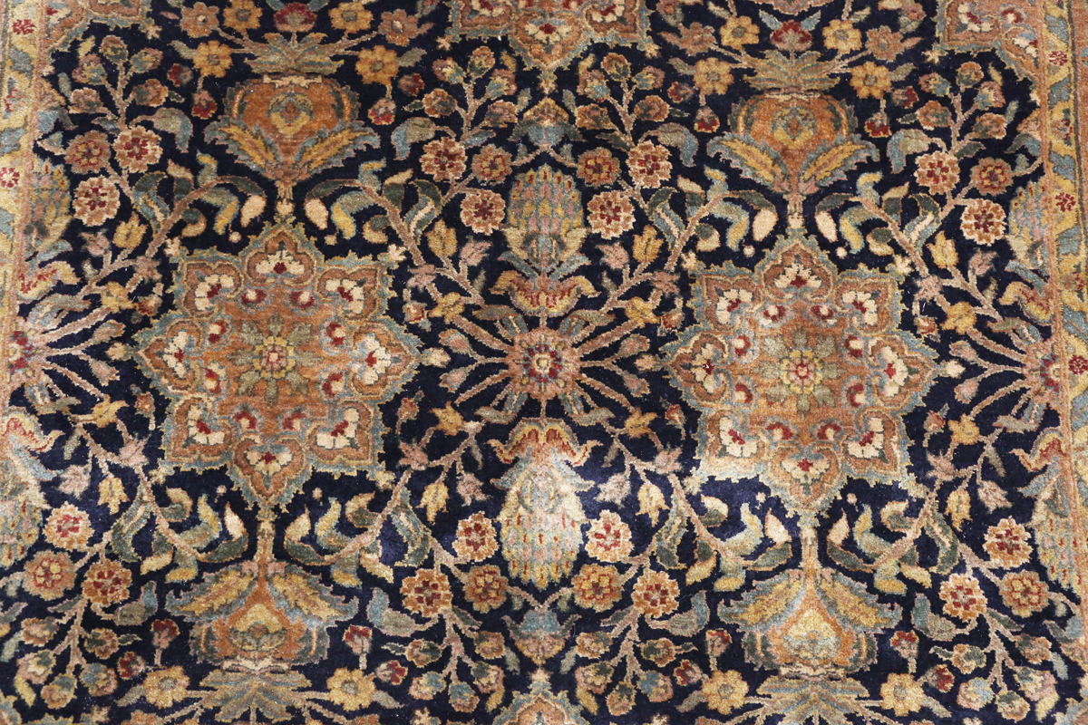 An Indian carpet, late 20th century, the charcoal field with overall palmettes, flowerheads and - Image 6 of 6